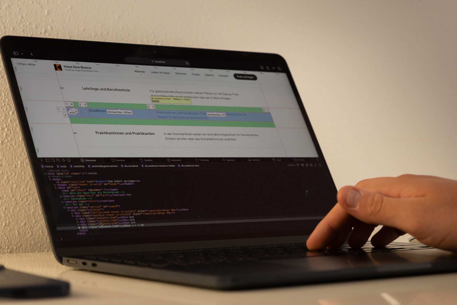 Laptop mit geöffnetem Code und Website-Entwurf am Schreibtisch in Freistadt
